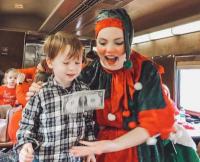 This elf is learning a parlor game with Conner as he enjoys the North Pole Express