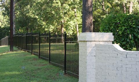Sloped Nashville yard with iron fencing