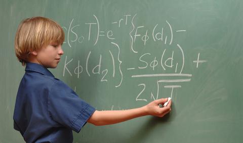 Young man completing a problem on the board of a Nashville private school