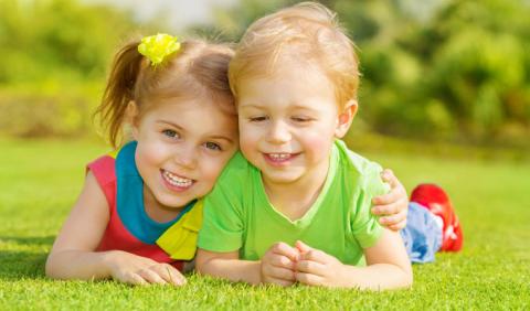 Two young kids smiling at a park in Nashville